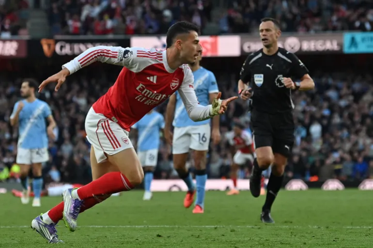 Le milieu de terrain brésilien n°11 d'Arsenal, Gabriel Martinelli, célèbre après avoir marqué son premier but lors du match de football de la Premier League anglaise entre Arsenal et Manchester City à l'Emirates Stadium de Londres le 21 septembre 2025.