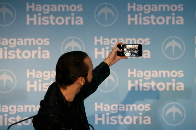 Nayib Bukele takes a selfie during a press conference in San Salvador in 2019, reflecting his preference for communicating directly via social media rather than through traditional media channels.