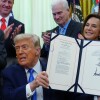 Le président Trump brandit un projet de loi finançant l’application des lois en matière d’immigration après l’avoir signé dans le bureau ovale de la Maison Blanche, le mercredi 10 juin 2026, à Washington. 