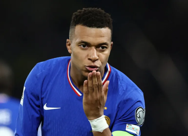 Mbappe kisses his hand in celebration