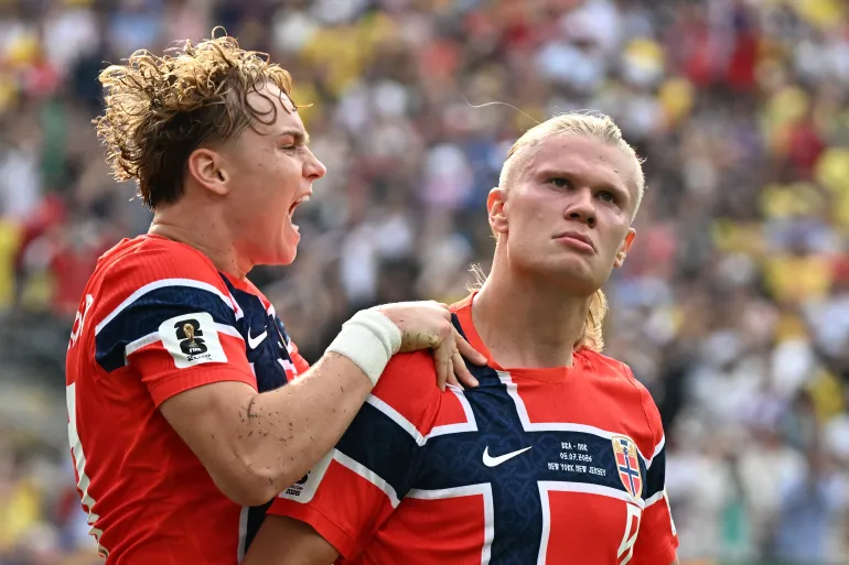 Norway's forward #09 Erling Braut Haaland (R) celebrates scoring his team's first goal with teammate midfielder #21 Andreas Schjelderup during the 2026 World Cup round of 16 football match between Brazil and Norway at the New York/New Jersey Stadium in East Rutherford on July 5, 2026.
